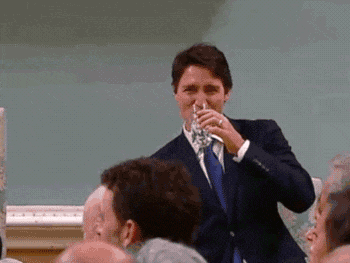 Justin Trudeau drinking water at event