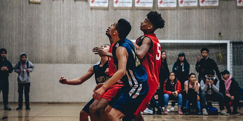 Group of young men playing basketball