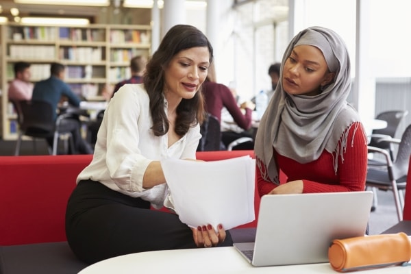 Women discussing in a library