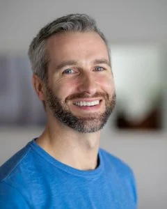 Man in blue shirt smiling