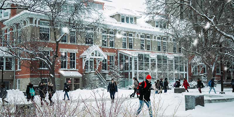 People walking outdoors in winter jackets and winter boots in Canada