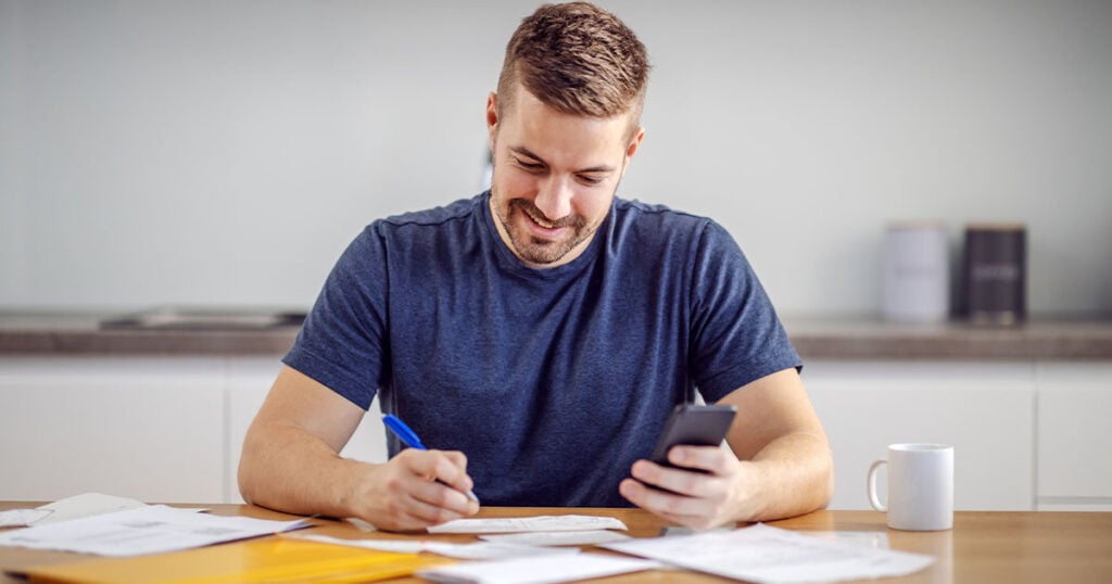 Man sitting at a table filling his taxes