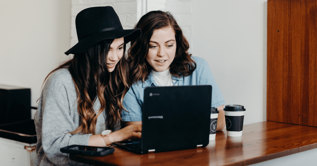 Two people working on a laptop.