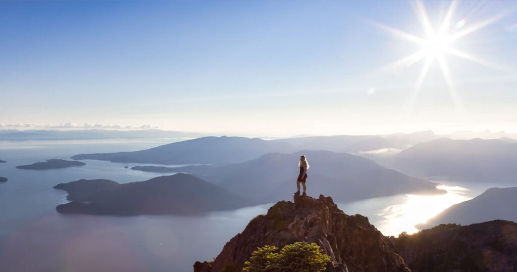 Young female hiker at the top of a mountain in British Columbia