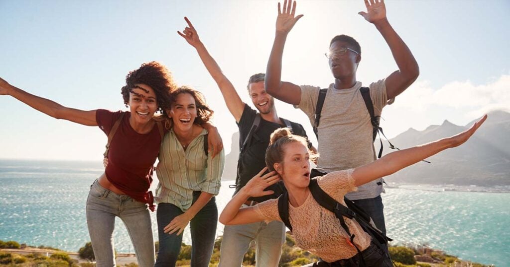 Young friends posing at the end of a hike