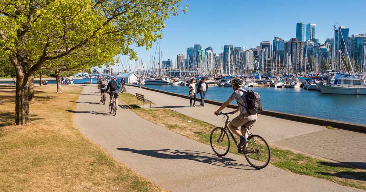 Bikers riding along the Vancouver Sea Wall.