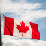 Canadian flag waving in the sky