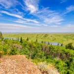 The conglomerate cap rock of the Cypress Hills (foreground) resisted erosion during the last ice age, preventing the tops of the Cypress Hills from being covered by the ice sheets.