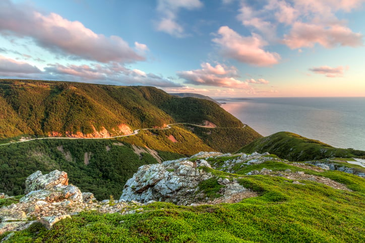 The winding Cabot Trail road seen from high above on the Skyline Trail at sunset in Cape Breton Highlands National Park, Nova Scotia