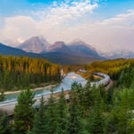 Train passing Morants Curve at sunrise.