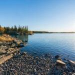 Frame Lake shore at sunset time, clear sky and sunlight. Yellowknife, Canada.