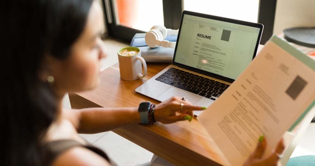 Woman sorting through resumes