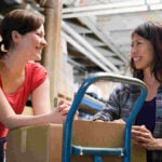 Two women working in a warehouse