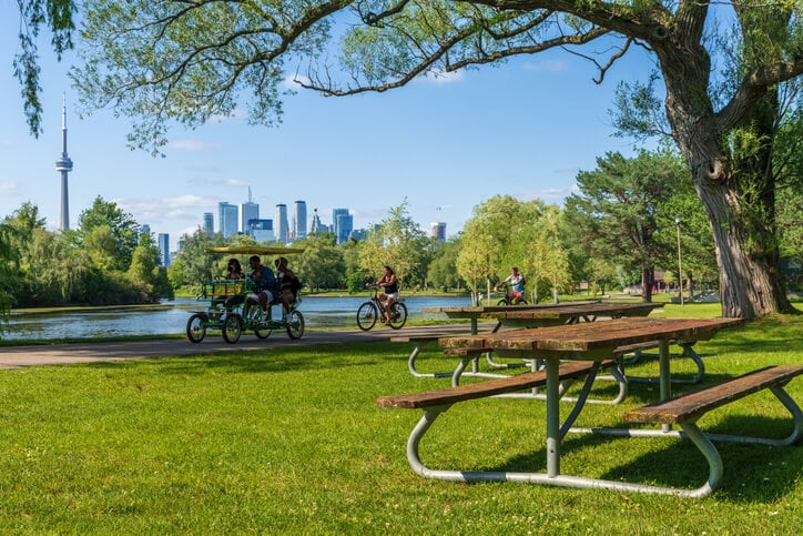 People riding a bike in the Toronto Island Park